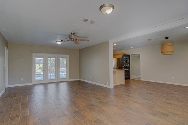 unfurnished living room featuring ceiling fan