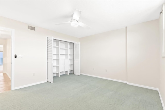 unfurnished bedroom with carpet floors, a closet, and ceiling fan