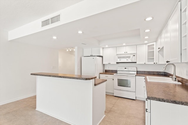 kitchen featuring sink, light tile patterned floors, a kitchen island, white appliances, and white cabinets