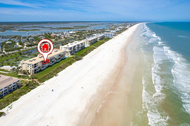 bird's eye view with a water view and a beach view