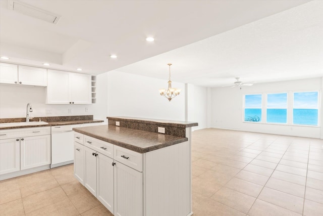 kitchen featuring white cabinets, dishwasher, sink, and ceiling fan with notable chandelier