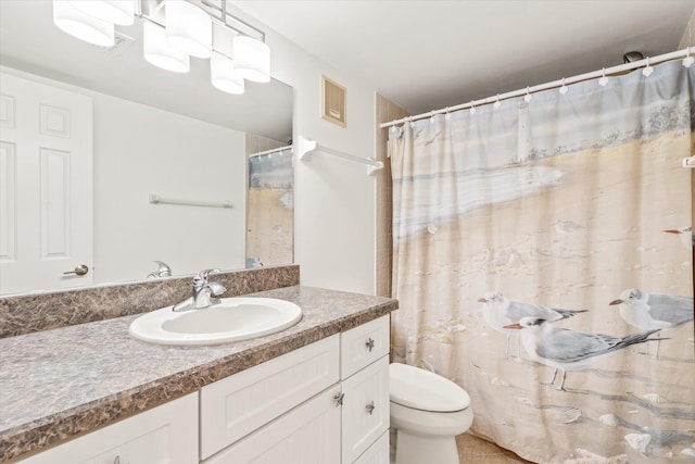 bathroom with tile patterned floors, vanity, and toilet