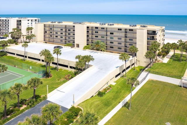 drone / aerial view featuring a water view and a beach view