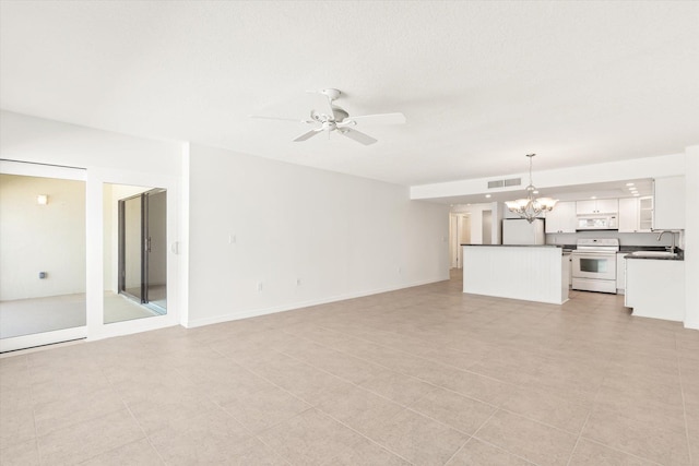 unfurnished living room featuring light tile patterned floors, ceiling fan with notable chandelier, and sink