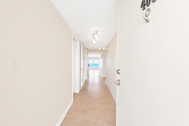 hallway featuring light tile patterned flooring