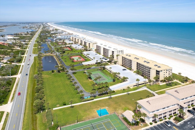 drone / aerial view featuring a water view and a beach view