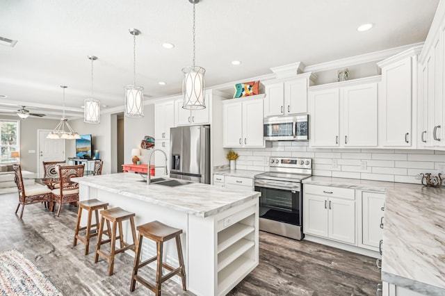 4954 A1A, Saint Augustine, FL 32080 - kitchen featuring appliances with stainless steel finishes, a sink, crown molding, decorative backsplash, and recessed lighting