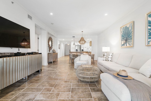 living room with recessed lighting, visible vents, and ornamental molding