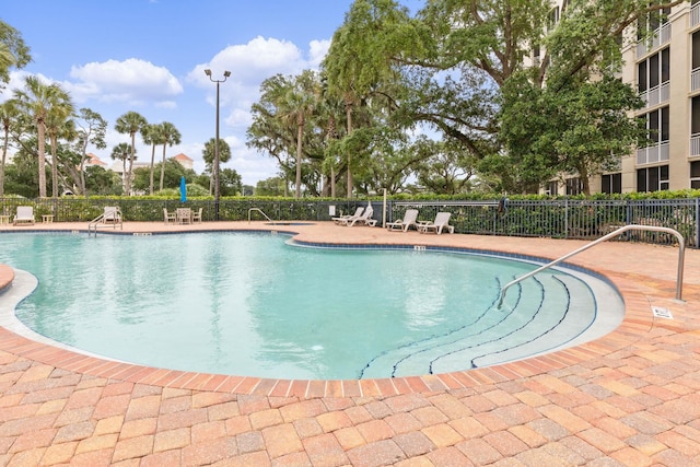 pool with fence and a patio