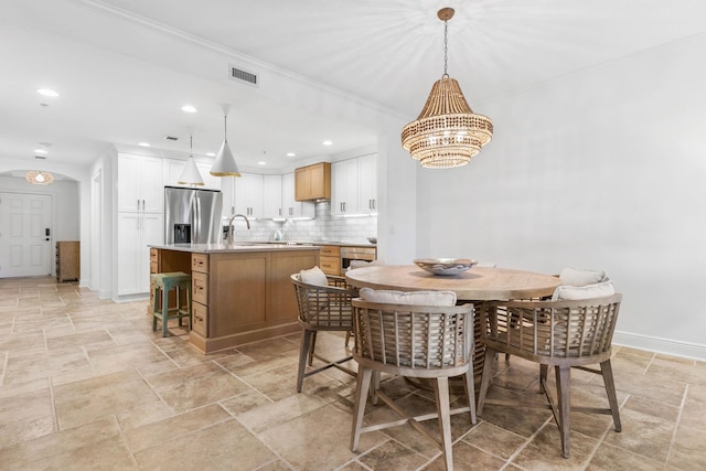 dining space featuring baseboards, stone finish flooring, recessed lighting, and an inviting chandelier