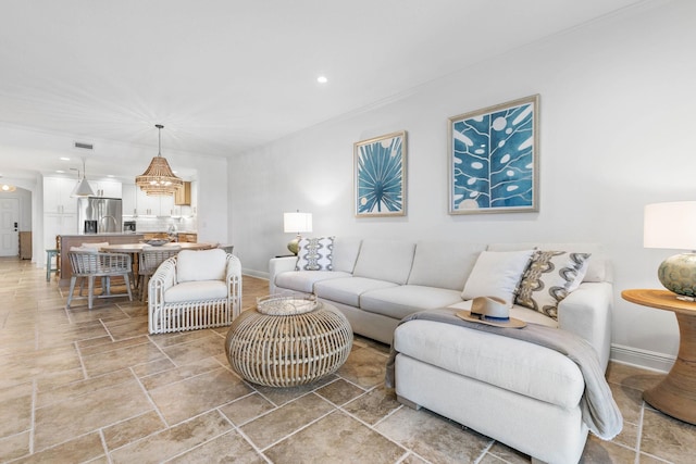 living room with stone finish flooring, recessed lighting, visible vents, and baseboards