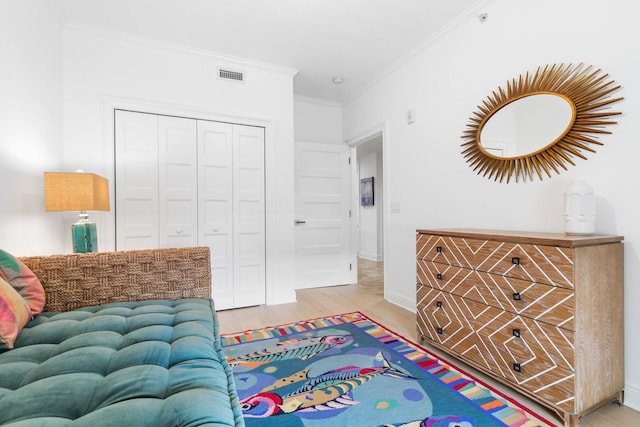 interior space featuring baseboards, crown molding, visible vents, and wood finished floors