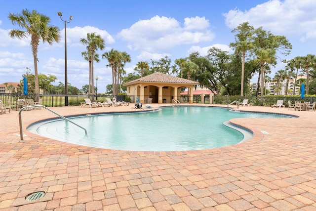 community pool featuring a patio area and fence