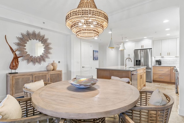 dining room featuring stone finish floor, a chandelier, crown molding, and recessed lighting