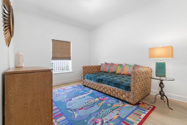 interior space with crown molding, baseboards, and wood finished floors