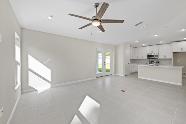 53 Pine Crest Ln, Palm Coast, FL 32164 - unfurnished living room with ceiling fan, baseboards, recessed lighting, light tile patterned flooring, and french doors