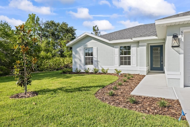 53 Pine Crest Ln, Palm Coast, FL 32164 - exterior space with a shingled roof and a lawn