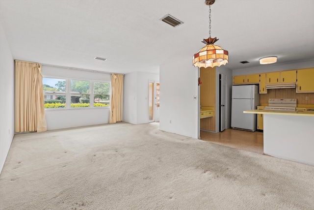 unfurnished living room featuring light carpet