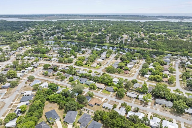 aerial perspective of suburban area with a nearby body of water
