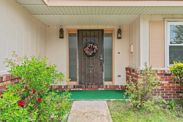 view of exterior entry with brick siding