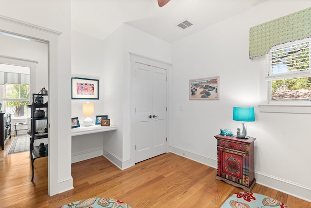 entrance foyer featuring hardwood / wood-style flooring, ceiling fan, and a wealth of natural light