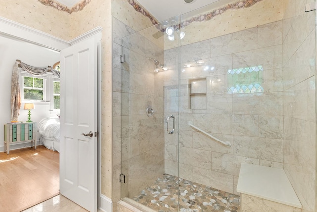 bathroom featuring a shower with door and hardwood / wood-style flooring