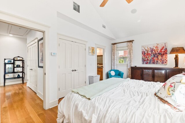 bedroom with ceiling fan, a closet, vaulted ceiling, and light wood-type flooring