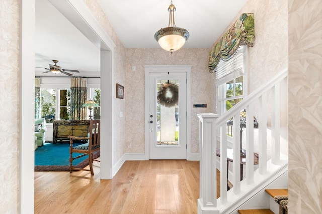 foyer entrance with hardwood / wood-style floors and ceiling fan