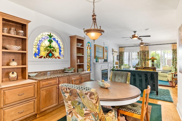 dining space featuring light hardwood / wood-style flooring and ceiling fan