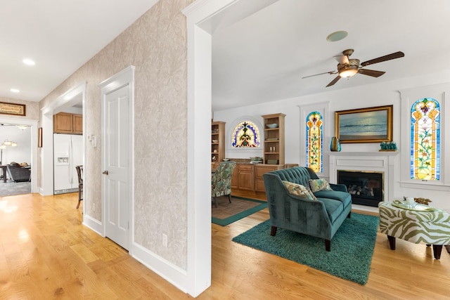 living room featuring ceiling fan and light wood-type flooring