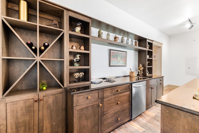 wine room featuring rail lighting and light hardwood / wood-style floors