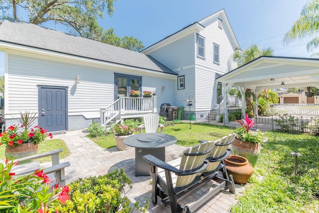 back of property with a patio area, a yard, and an outdoor fire pit