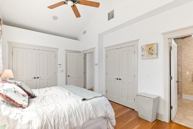 bedroom featuring high vaulted ceiling, light hardwood / wood-style flooring, and ceiling fan