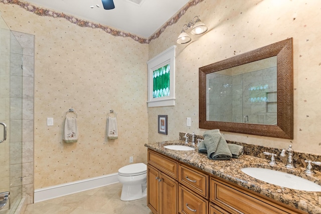 bathroom featuring vanity, toilet, and a shower with shower door