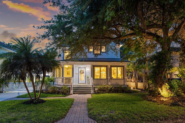 view of front of home featuring a lawn and a porch