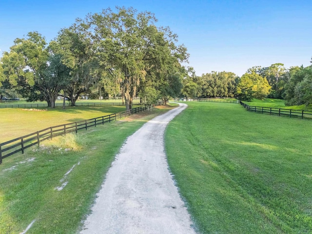 view of community with a yard and a rural view