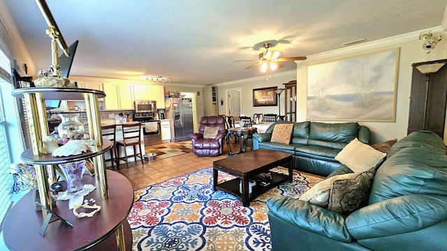 living room featuring ornamental molding and ceiling fan