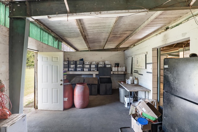 misc room featuring concrete flooring and vaulted ceiling