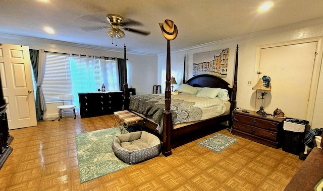 bedroom featuring ceiling fan, ornamental molding, and light parquet flooring