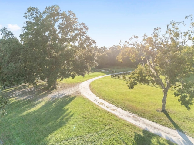 surrounding community with a lawn and a rural view