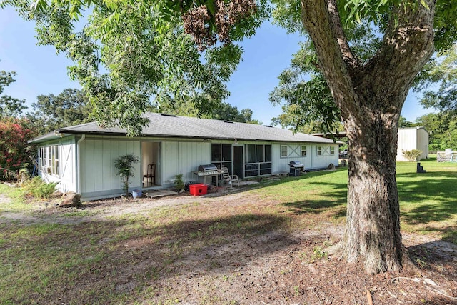 rear view of property featuring a lawn