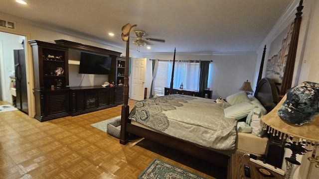 bedroom with light parquet floors, crown molding, black fridge, and ceiling fan