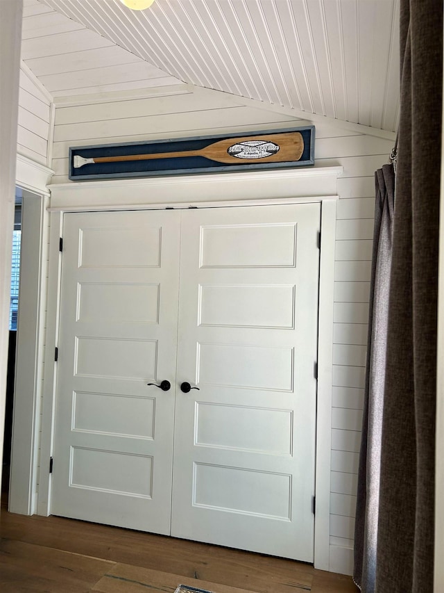 details with wood-type flooring, wooden ceiling, and wood walls