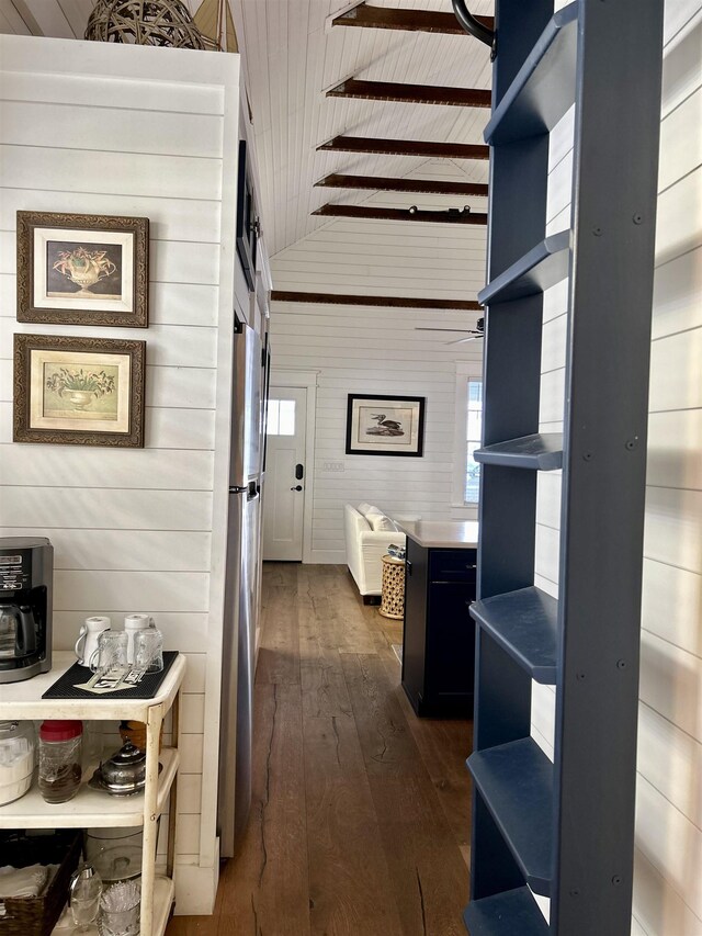 hallway with dark hardwood / wood-style flooring, wooden walls, high vaulted ceiling, wooden ceiling, and beamed ceiling