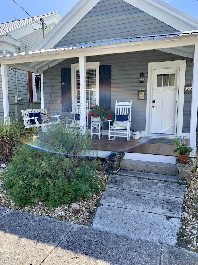 doorway to property featuring a porch