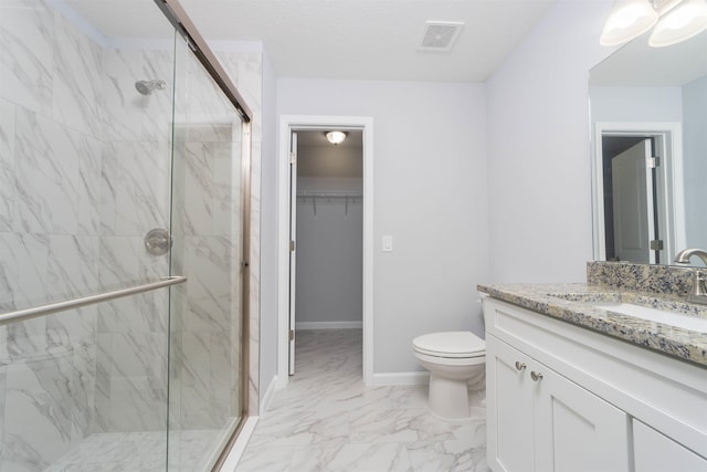 bathroom with vanity, an enclosed shower, and toilet