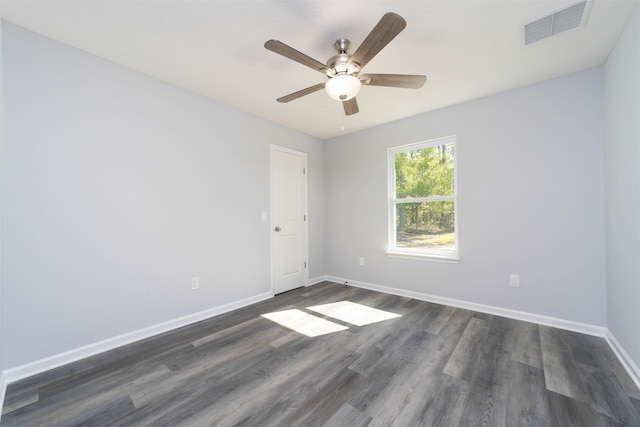 spare room with ceiling fan and dark wood-type flooring