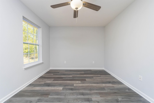 unfurnished room with ceiling fan and dark wood-type flooring