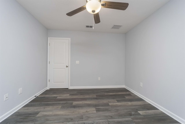 empty room with dark hardwood / wood-style floors and ceiling fan