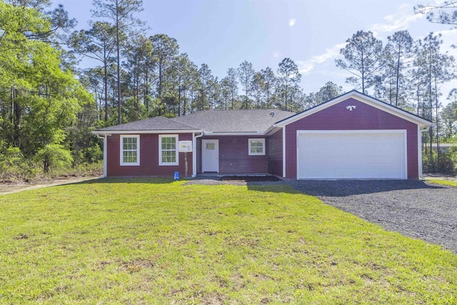 ranch-style house featuring a garage and a front lawn